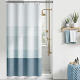 Jinchan small stall shower curtain with ombre ocean blue stripes adds coastal style and privacy.