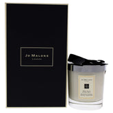 Jo Malone Wood Sage and Sea Salt candle in the jar enhances coastal luxury ambiance.