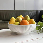 JolieJulie ceramic fruit bowl in cream white on kitchen counter as a stylish centerpiece.