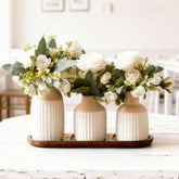 Jonronboci artificial flowers in ceramic vases with wood tray for a timeless centerpiece.