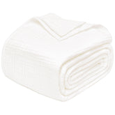 Joydeco muslin throw blanket on white sofa for breathable year-round comfort