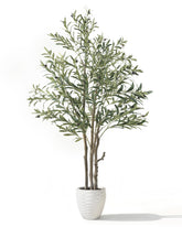 KOL 6ft artificial olive tree indoors elevates living room greenery.