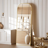 Koonmi full-length mirror with gold domed top enhances room style and full-body visibility.