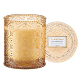 LA JOLIE MUSE amber-sandalwood candle jar offers warm ambience for evenings.