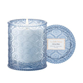 LA JOLIE MUSE Citrus Mint Candle in an embossed daisy jar enhances elegant décor.