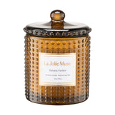 LA JOLIE MUSE Sahara Amber Candle in hobnail jar creates a warm ambiance for cozy evenings.