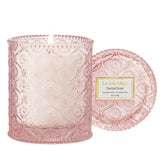 LA JOLIE MUSE Santal Rose candle in an embossed jar enhances elegant home décor.