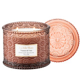 La Jolie Muse Tomato Vine Candle jar showcases a vibrant garden scent for warm living spaces.