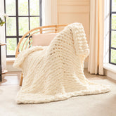 L'AGRATY chunky knit blanket 40x50 draped on a couch for cozy warmth.