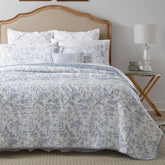 Laura Ashley Amberley Blue king quilt set on bed, showing soft cotton fabric and elegant color.