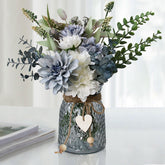 Leftover fake flowers in vase with dahlia bouquet for elegant table decor