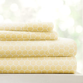 Linen Market honeycomb yellow patterned microfiber queen sheet set on bed, inviting and breathable