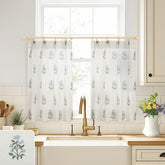 Lino Rosa cafe curtains over kitchen sink with pinch-pleat design and blue-green floral print.