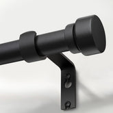 Lootkell matte black curtain rod with solid metal finials provides stable support for drapes