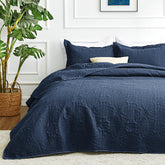 Love's cabin Cal King navy quilt on bed for year-round comfort.