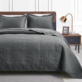 Love's cabin king-size quilt in dark grey with soft embossed texture.