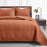 Love's cabin king size quilt in umber on bed for year-round comfort