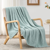 Love's Cabin six-layer muslin blanket on a couch for all-season comfort