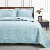 Love's cabin oversized king quilt spa-blue on bed, setup for year-round comfort.