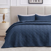 Love's cabin quilt in navy blue on a queen bed for year-round comfort.