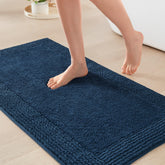 Madison Park Splendor navy bath rug with plush tufted pile for luxurious underfoot comfort.