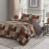 Madison Park queen quilt patchwork on bed enhances cozy lodge vibes.