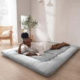 MAXYOYO Japanese floor mattress folded for easy storage and portability.