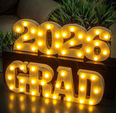 Meadin Grad 2026 LED letters glow as a table centerpiece for graduation parties