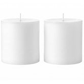 Mister Candle 4x4 unscented pillar candle lighting a table centerpiece.