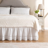 MIYE wrap around ruffled lace bed skirt on bed shows elegant embroidery for a refined look