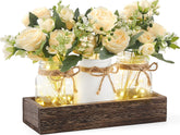 Mkono mason jar lights centerpiece on wooden box for warm dining table ambiance.