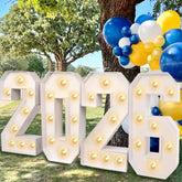 Mythcloud 2026 marquee numbers illuminate photos with a bright, reusable backdrop.