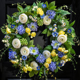 NaturaWre spring wreath on front door highlighting hydrangea blooms for curb appeal.