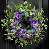 NaturaWre 24-Inch spring wreath on front door with hydrangea and thistle enhances curb appeal