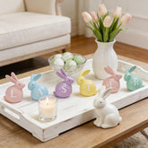 Newman House Studio Easter bunny centerpieces for table setup with six colorful hand-painted figurines.