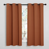 NICETOWN burnt orange curtains close-up showing triple-weave blackout fabric.