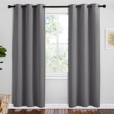 NICETOWN grey blackout curtain panel with silver grommets for smooth opening and privacy.