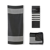 Nomadix Original Towel beach scene showing ultra-absorbent action for quick drying