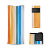 Nomadix Original Towel on the beach with a sand-resistant surface for easy cleanup.