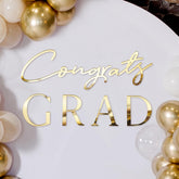 Novabright Congrats Grad Sign backdrop in gold acrylic mirrors for elegant graduation photos.