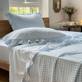 NSNLGSGC light blue gingham ruffle queen sheet set on bed for cozy farmhouse style.