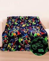 NuKuNsKf glow blanket in navy on couch ideal for late-night gaming comfort.
