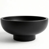 OAKOA concrete bowl with unique artwork enhances fruit display.