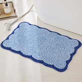 Ohocut navy scalloped piping bath rug adds plush coastal style to the bathroom.