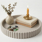 OAKOA round decorative concrete tray used as a stylish coffee table centerpiece