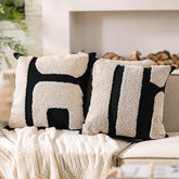 Oudain black and white tufted pillow cover closeup highlighting soft polyester texture.