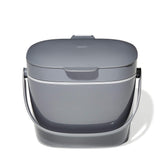 OXO Good Grips compost bin in charcoal on the counter for neat scraps.