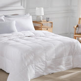 Pacific Coast lightweight goose down fiber comforter offers airy warmth for spring and summer.