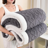 PAJEO Sherpa blanket on a bed for full-size warmth and coziness.
