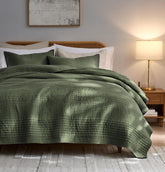 Palassio striped olive green quilt queen set on bed for year-round comfort